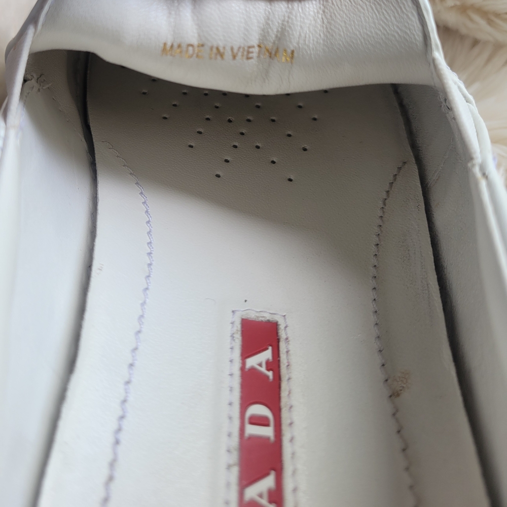 Prada White & Silver  Leather Shoes. It Can Be Wear By Women Or Men